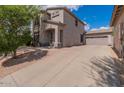 Charming stucco home featuring a two-car garage, desert landscaping, and a welcoming front entry at 7304 E Northridge Cir, Mesa, AZ 85207