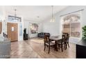 Bright open-concept living and dining area with large windows, wood and tile flooring, and neutral paint at 741 W Harvard Ave, Gilbert, AZ 85233