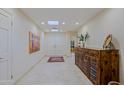 Bright foyer with tile flooring, skylights, and stylish console table at 8138 E Via De La Escuela --, Scottsdale, AZ 85258