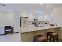 Modern kitchen featuring white cabinets, stainless steel appliances, and a granite countertop island with seating at 8138 E Via De La Escuela --, Scottsdale, AZ 85258
