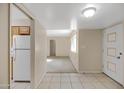 Bright entryway with tile flooring and a glimpse of the living room at 829 S Revolta Cir, Mesa, AZ 85208