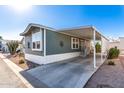 Well-maintained manufactured home with covered parking and desert landscaping at 8865 E Baseline Rd # 1731, Mesa, AZ 85209