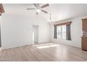 Bright living room with hardwood floors, ceiling fan and light and neutral decor at 8865 E Baseline Rd # 1731, Mesa, AZ 85209