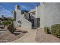 Well-maintained building exterior featuring neutral stucco, tile roofs, and desert landscaping at 10115 E Mountain View Rd # 2042, Scottsdale, AZ 85258