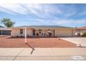 Charming home featuring a cozy front porch with seating, a garage, and well-maintained yard at 10511 W Edgewood Dr, Sun City, AZ 85351