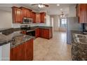 Spacious kitchen featuring cherry wood cabinets, and stainless steel appliances at 11011 N Zephyr Dr # 106, Fountain Hills, AZ 85268