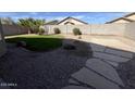 Low maintenance backyard featuring desert landscaping and a concrete patio at 11946 W Jackson St, Avondale, AZ 85323