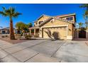 Two-story home with a spacious driveway and a well-maintained front yard at 1202 E Milada Dr, Phoenix, AZ 85042