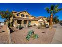 Charming two-story home featuring a cozy front porch and desert landscaping at 1202 E Milada Dr, Phoenix, AZ 85042