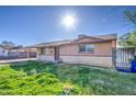 Exterior shot of the house with sunny skies, featuring a covered carport and desert landscaping at 1340 N Oregon St, Chandler, AZ 85225