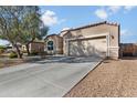 Charming single-story home with a two-car garage, neutral stucco, and terracotta roof tiles at 13624 W Desert Moon Way, Peoria, AZ 85383