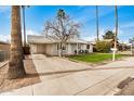 Inviting single-story home with covered carport, mature trees, and pleasant frontage at 14008 N 61St Ave, Glendale, AZ 85306