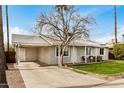 Quaint single-level home with a covered carport and easy access driveway at 14008 N 61St Ave, Glendale, AZ 85306