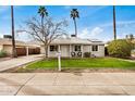 Charming single-story home with a well-manicured lawn and classic curb appeal at 14008 N 61St Ave, Glendale, AZ 85306