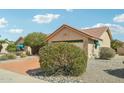 This single-story home features an attached garage, desert landscaping, and a tile roof at 14432 W Yukon Dr, Sun City West, AZ 85375