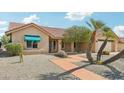 Well-maintained home showcases desert landscaping, covered entry, and a welcoming facade at 14432 W Yukon Dr, Sun City West, AZ 85375