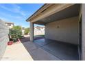 A covered patio offers a relaxing outdoor space with views of the backyard and surrounding landscape at 14616 W Ventura St, Surprise, AZ 85379