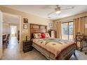 Comfortable bedroom with a ceiling fan, sliding glass doors and decorative furnishings at 14910 N Kings Way # 101, Fountain Hills, AZ 85268