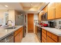 Well-lit kitchen featuring wood cabinetry, stainless steel appliances, and spacious countertops at 14910 N Kings Way # 101, Fountain Hills, AZ 85268