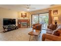 Cozy living room featuring a fireplace, tile flooring, and sliding glass doors to the patio at 14910 N Kings Way # 101, Fountain Hills, AZ 85268