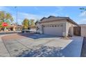 Charming single-story home featuring a two-car garage, low maintenance desert landscaping, and a wide driveway at 151 N 116Th Dr, Avondale, AZ 85323