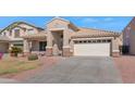 Beautiful home with a well-maintained lawn and a spacious two-car garage at 16102 W Miami St, Goodyear, AZ 85338