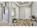 Inviting entryway with decorative flooring, a white front door, and neutral paint at 17138 W Las Palmaritas Dr, Waddell, AZ 85355