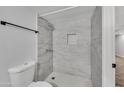 Updated bathroom featuring a tiled shower with a built-in niche, complemented by modern fixtures and neutral colors at 17211 N 35Th Ave, Phoenix, AZ 85053