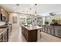 A view of the kitchen with a large center island and stainless steel appliances, open to the living area at 17963 E Silver Sage Ln, Rio Verde, AZ 85263