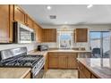 Modern kitchen featuring stainless steel appliances and wooden cabinetry at 1992 E Shetland Dr, San Tan Valley, AZ 85140