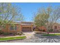 Charming home featuring a two-car garage, complemented by beautiful landscaping and mature trees at 20785 W Canyon Dr, Buckeye, AZ 85396