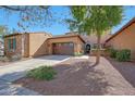 Attractive home with a two-car garage, desert landscaping, and a welcoming entrance at 20785 W Canyon Dr, Buckeye, AZ 85396