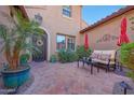 Inviting outdoor patio space featuring stylish furniture, colorful umbrellas, and lush greenery at 20785 W Canyon Dr, Buckeye, AZ 85396