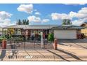 Cozy single-story house featuring stone accents and a covered carport offering shade and curb appeal at 238 N 62Nd St, Mesa, AZ 85205