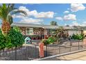 Exterior shot featuring a single-story stone home with a landscaped yard, and covered parking at 238 N 62Nd St, Mesa, AZ 85205