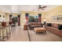 Comfortable living room with a ceiling fan and bar seating area, perfect for entertaining guests at 25609 N 54Th Ln, Phoenix, AZ 85083