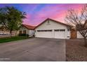 A well-maintained single-Gathering home featuring a three car garage and desert landscaping at 2646 N Robin Ln, Mesa, AZ 85213