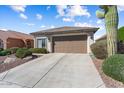 A well-maintained single-story home with a two-car garage and concrete driveway at 27108 W Escuda Dr, Buckeye, AZ 85396