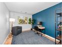 Bright office featuring a blue accent wall, natural light, and a functional workspace at 28871 N Coal Ave, San Tan Valley, AZ 85143