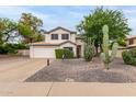 Charming two-story home with a two-car garage, desert landscaping, and mature Saguaro cacti at 3034 N Ricardo --, Mesa, AZ 85215