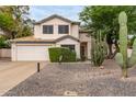 Charming two-story home with a two-car garage, desert landscaping, and mature Saguaro cacti at 3034 N Ricardo --, Mesa, AZ 85215