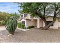 Charming two-story home with desert landscaping, large shade tree, and stucco pillars on the front porch at 3034 N Ricardo --, Mesa, AZ 85215