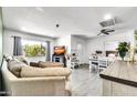 Bright and airy living room featuring neutral-toned furniture, and a large window showcasing the outdoor greenery at 3129 W Pierce St, Phoenix, AZ 85009