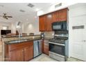 This kitchen features granite countertops, stainless steel appliances, and wooden cabinets at 3428 E Lance Ln, Phoenix, AZ 85018