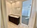 Bathroom featuring a double vanity, a granite countertop, and a view into the bedroom at 35436 N Breezy Ln, San Tan Valley, AZ 85140