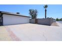 Spacious side yard with a concrete pad and brick accents providing extra parking and storage at 3547 W Encanto Blvd, Phoenix, AZ 85009