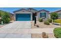 Charming single-story home with a well-manicured front yard and inviting blue garage door at 40176 W Williams Way, Maricopa, AZ 85138