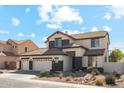 Charming two-story home showcasing a three-car garage and a well-maintained, low-water, desert-style front yard at 4043 W Aire Libre Ave, Phoenix, AZ 85053