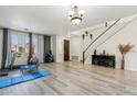 Spacious living area featuring wood-look floors, and large windows providing ample natural light at 4043 W Aire Libre Ave, Phoenix, AZ 85053