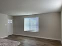 Bright living room featuring a front door, wood flooring, and a large window at 416 W Mission Ln, Phoenix, AZ 85021